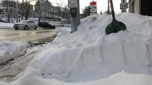 Snow piled up at a street corner.
